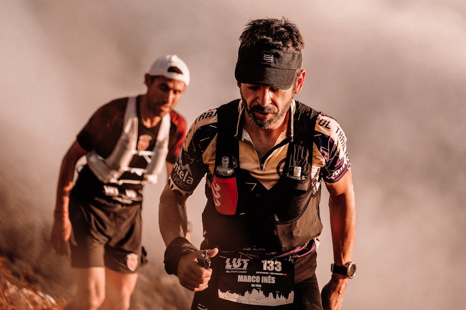 Two male athletes competing in a challenging outdoor trail race with determination.